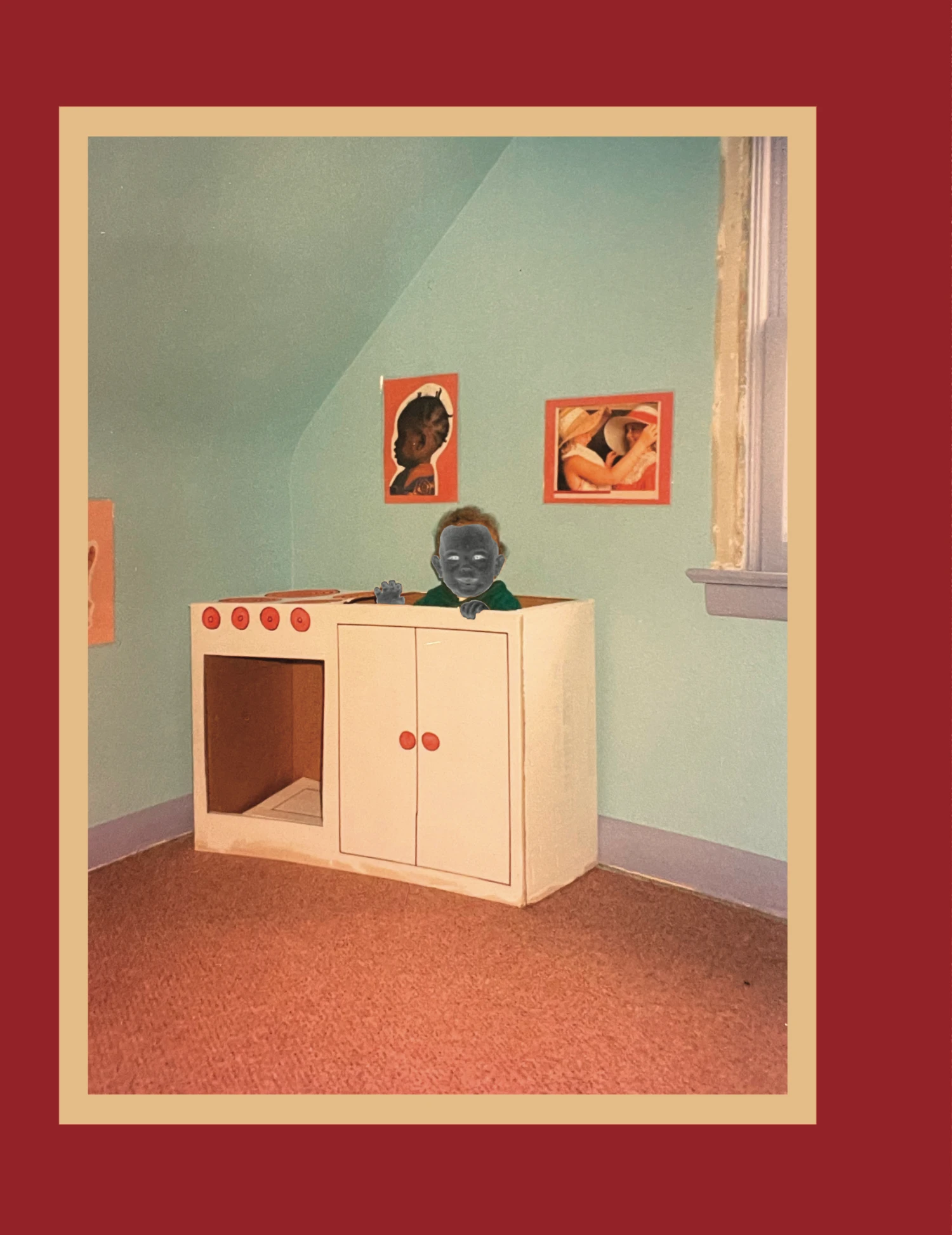 A toy kitchen and framed artwork in a colourful room, bordered in red