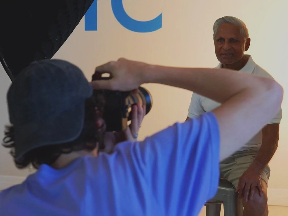 A community member having a portrait taken for the mural
