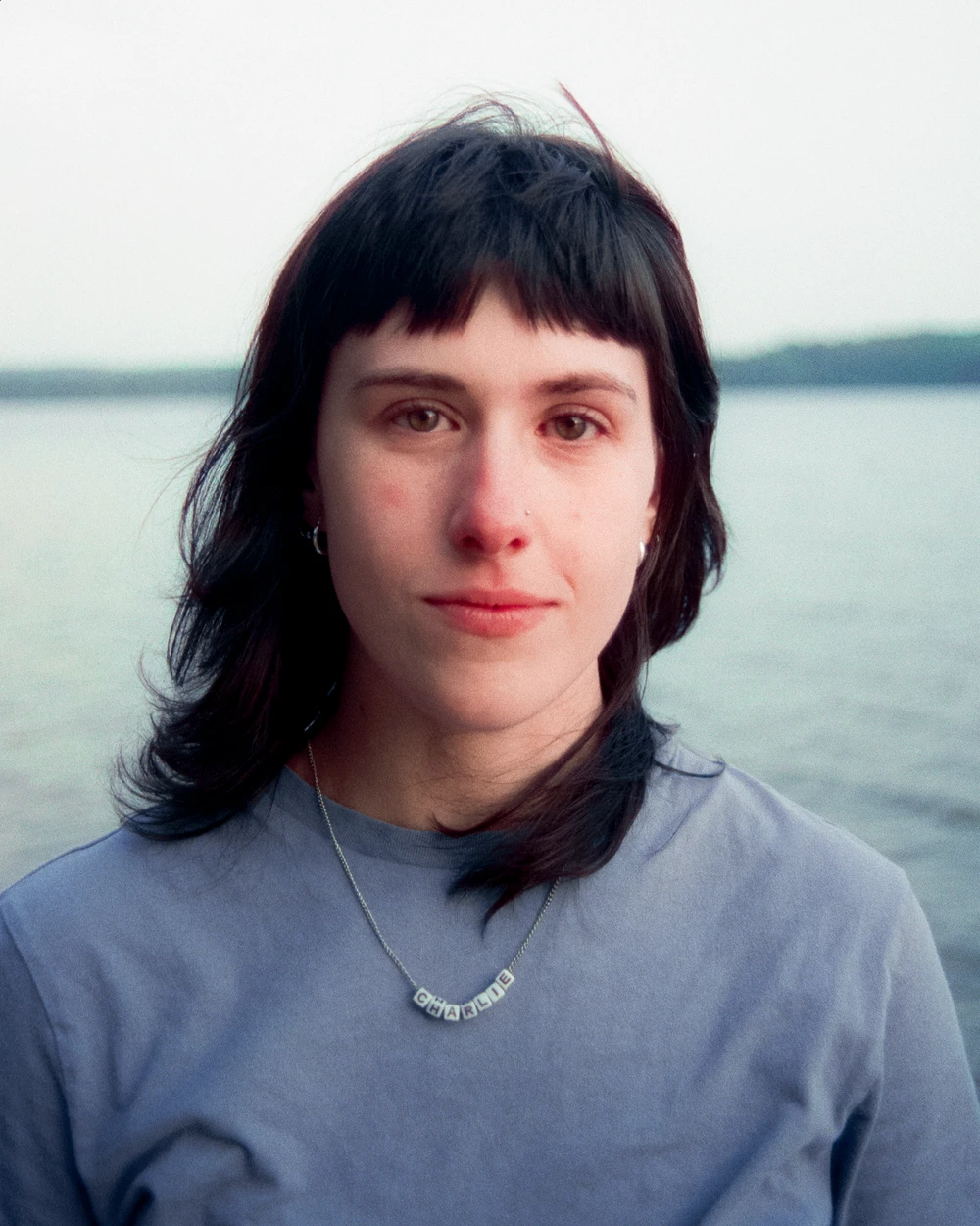 Portrait of a woman with dark hair by the lake